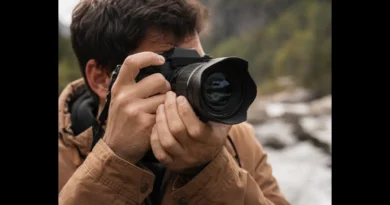 Photographer demonstrating how to fix shaky hands photography by holding a mirrorless camera securely at eye level outdoors.
