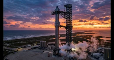 Aerial photograph of the SpaceX Starship Flight 13 launch stack, including the Super Heavy booster and Starship upper stage, actively venting and billowing smoke at the Starbase launch tower in Boca Chica, Texas, set against a dramatic sunset sky over the Gulf of Mexico.