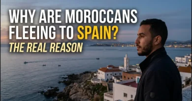 A young Moroccan man looking thoughtfully across the Strait of Gibraltar toward Spain at twilight, illustrating the blog post title "Why Are Moroccans Fleeing to Spain?"
